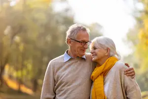 Happy senior couple outdoors, representing ocular disease screenings.