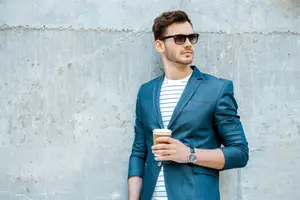 Man in sunglasses holding coffee cup, promoting UV protection eyewear.