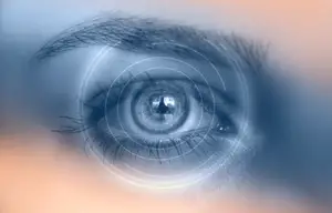 Close-up of human eye with digital graphics representing vision technology.